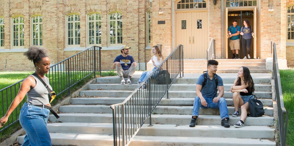 Students walking and sitting on campus.